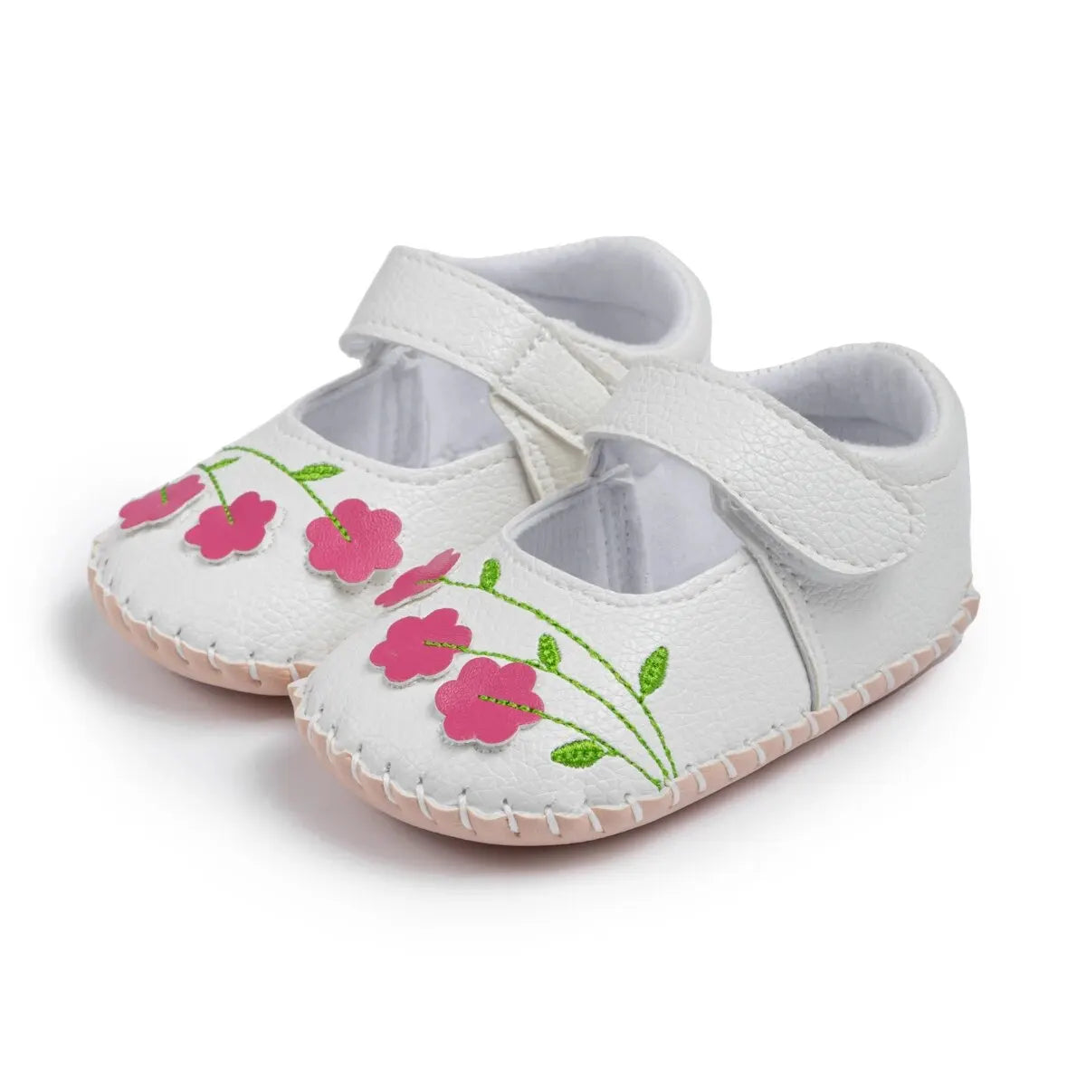 Pair of white PU leather baby girl Mary Jane shoes with pink embroidered flowers and green leaves on a white background.