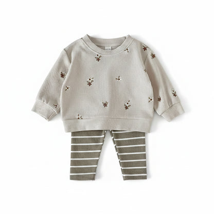 Baby and toddler girl 2-piece outfit set featuring a cream ribbed floral embroidered sweatshirt and olive green striped pants.