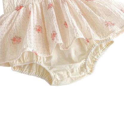 Back view of the baby girl floral romper showing the flowing chiffon tutu skirt and champagne bodysuit base.