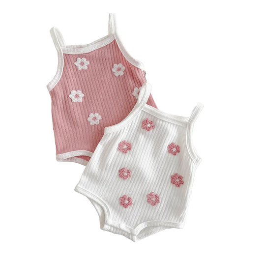 Two baby girl ribbed sleeveless rompers in pink and white featuring 3D floral towel embroidery on a clean white background.