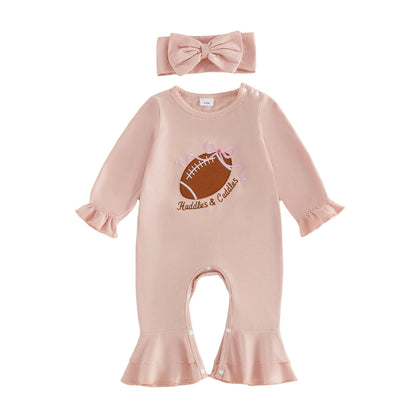Flat lay of a baby girl pink long-sleeve jumpsuit featuring a football embroidery and matching bow headband.