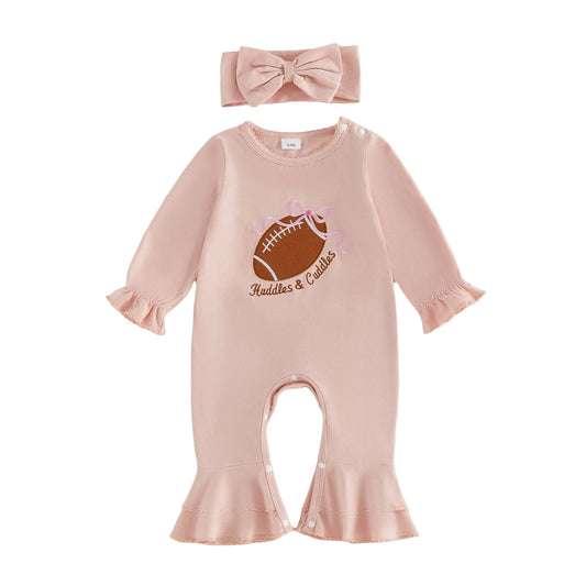 Flat lay of a baby girl pink long-sleeve jumpsuit featuring a football embroidery and matching bow headband.