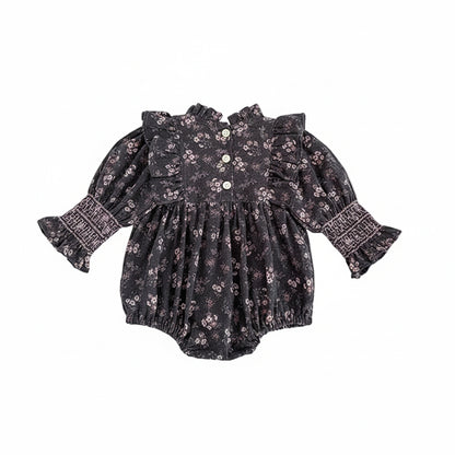Back view of baby girl grey floral smocked long sleeve romper showing back neck button closure.