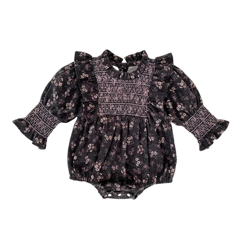 Baby girl grey floral smocked long sleeve romper with ruffle shoulders and elastic sleeve cuffs laid flat.