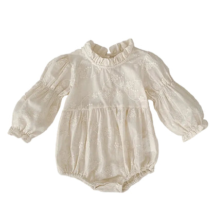 Front view of baby girl ivory floral embroidered cottagecore bubble romper with long bishop sleeves.