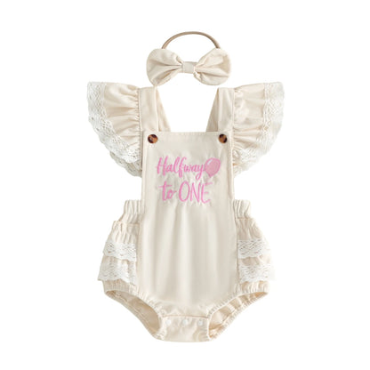 Ivory baby girl "Halfway to One" 6-month birthday romper outfit with matching bow headband, featuring lace ruffle sleeves.