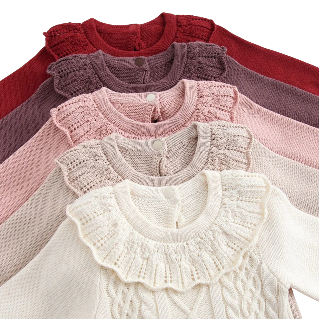 Back view detail of stacked frill collars showing button closures on Kidsely baby sweater rompers.