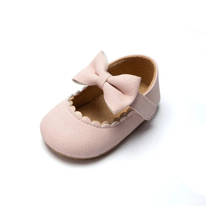 Soft pink infant first walker shoes with scalloped edge and decorative bow