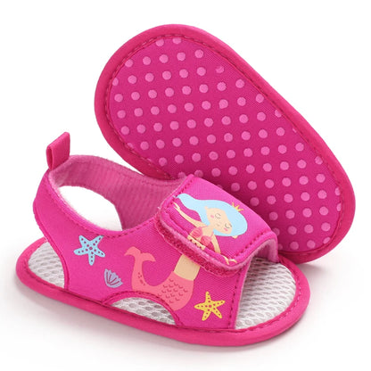 Bottom view of hot pink baby girl mermaid sandals showing the anti-slip dotted grip sole.