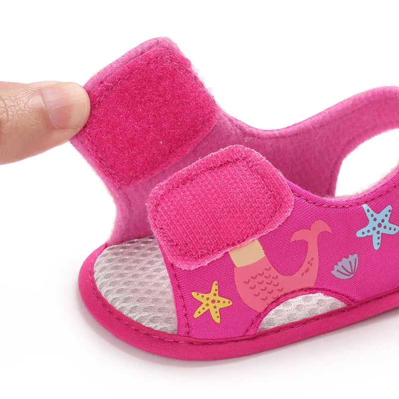 Hot pink baby girl mermaid sandal showing the open hook-and-loop velcro strap.