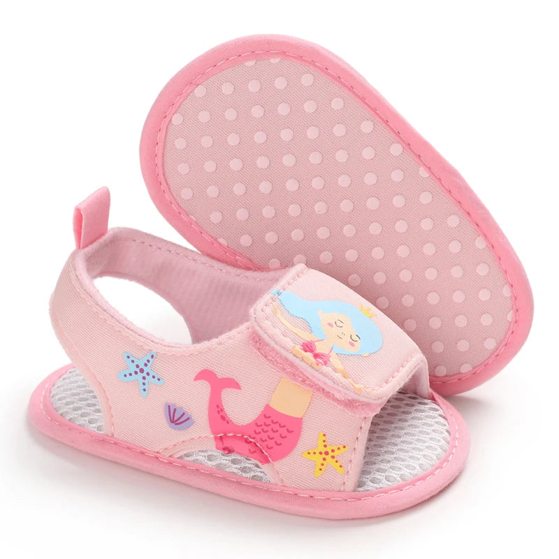 Bottom view of light pink baby girl mermaid sandals showing the anti-slip dotted grip sole.