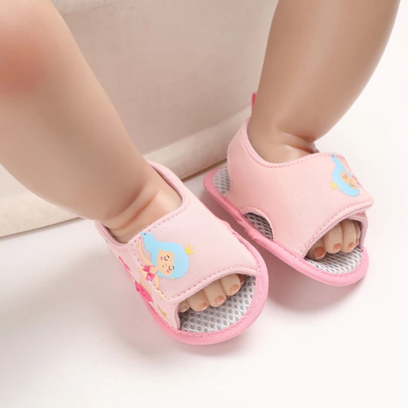 Baby wearing a pair of light pink mermaid soft sole sandals on their feet.