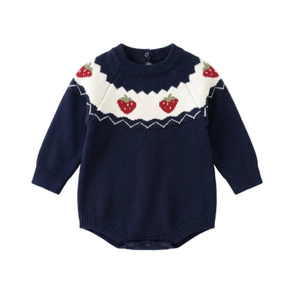 Flat lay of a baby girl navy blue long sleeve knit sweater romper featuring a white scalloped yoke with a knit strawberry pattern.