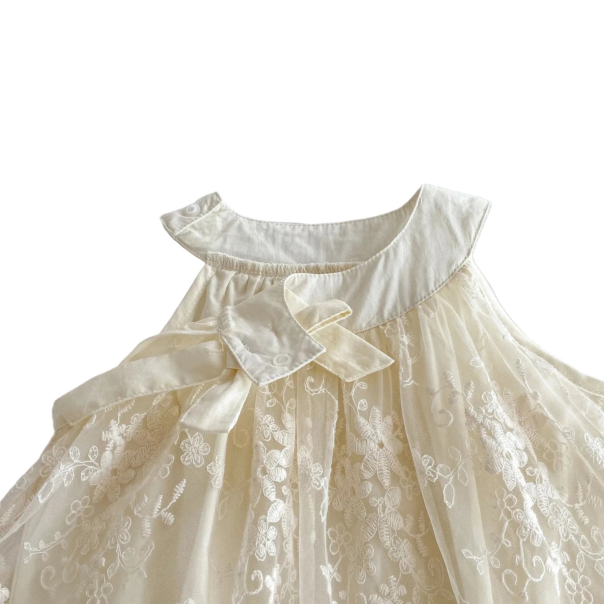Close-up flat lay focusing on the intricate sheer floral lace paneling draped across the front chest of the baby girl princess bodysuit.