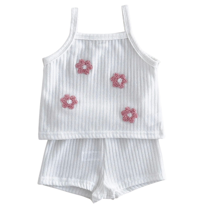 Front view studio flat lay of the petal white 2-piece baby girl summer ribbed tank and shorts set with pink 3D flower appliqués.