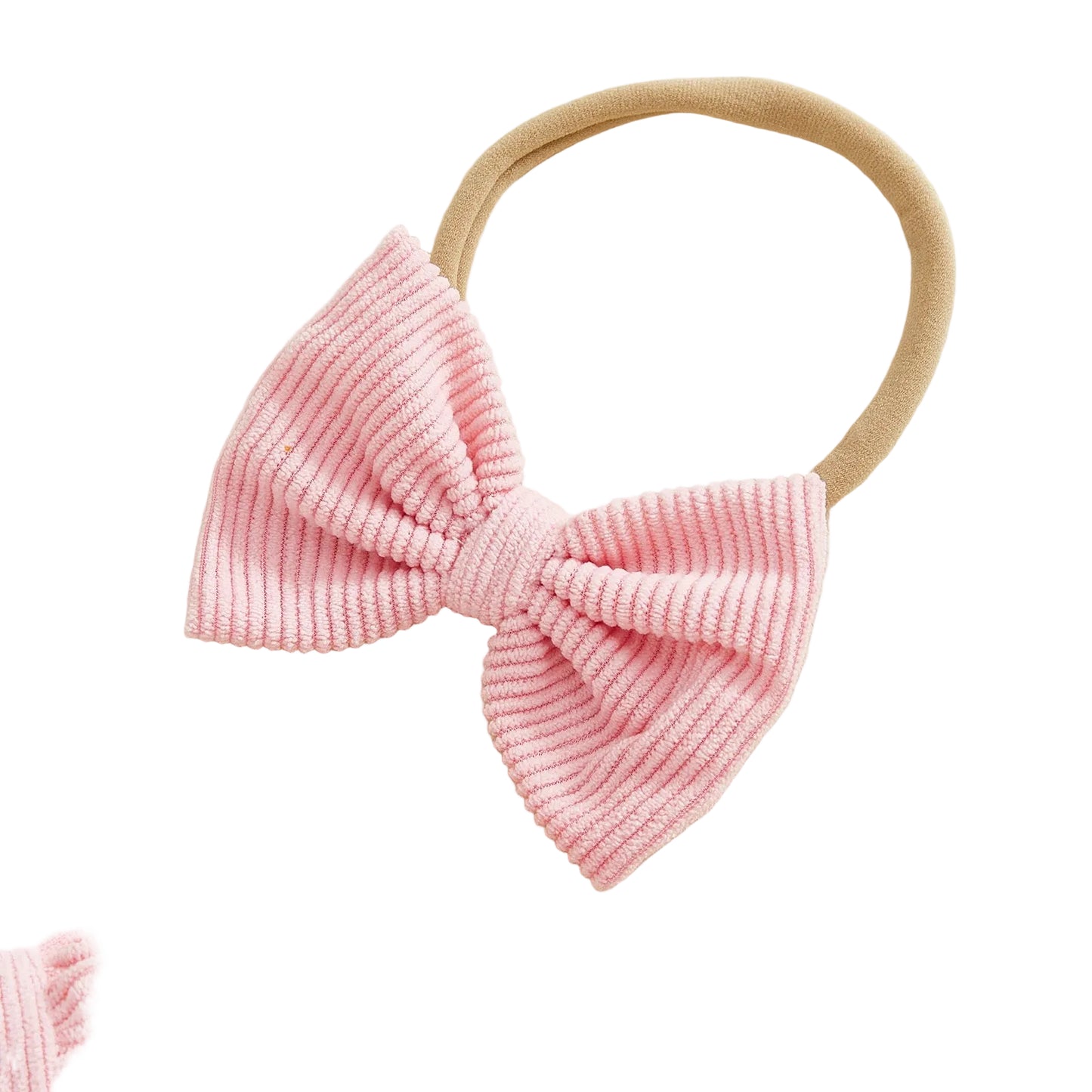 Close-up of pink soft corduroy bow headband for baby girl