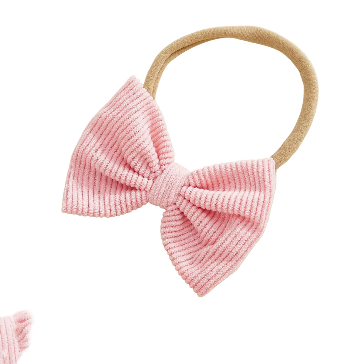 Close-up of pink soft corduroy bow headband for baby girl
