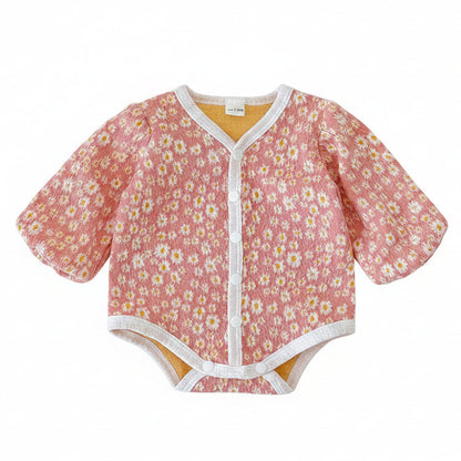 Front view of the baby girl pink daisy floral long sleeve bubble romper laid flat on a white background.