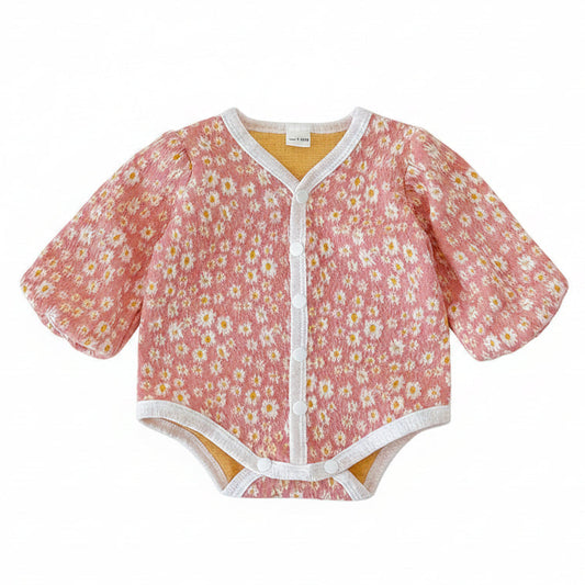 Front view of the baby girl pink daisy floral long sleeve bubble romper laid flat on a white background.