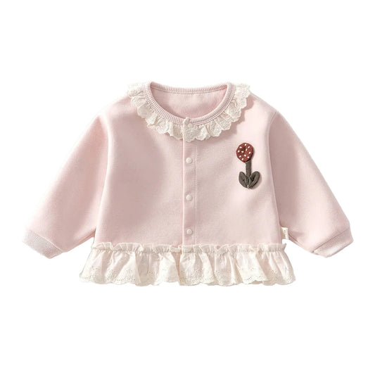 Soft pink baby and toddler girl knit cardigan sweater featuring a 3D floral applique and white lace trim collar and hem on a white background.