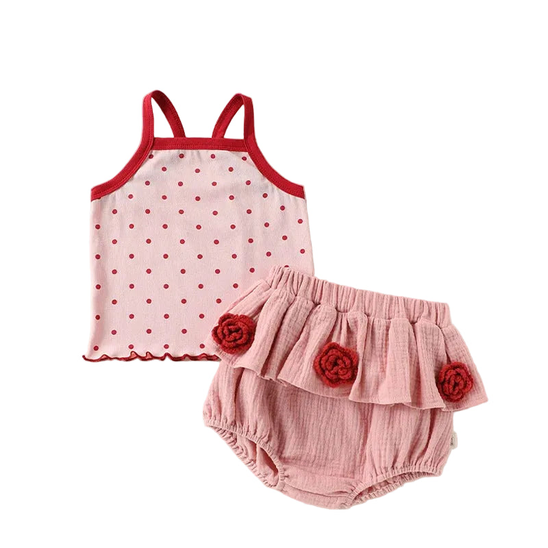 Two-piece baby girl summer clothing set featuring a pink sleeveless top with red polka dots and matching pink tiered ruffle bloomers with red fabric rosette flowers.