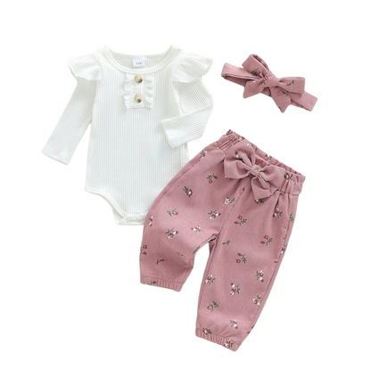 Baby girl 3-piece fall outfit set featuring a white ribbed long-sleeve romper, pink floral corduroy pants, and matching bow headband.