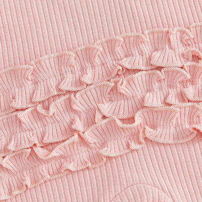 Close-up detail of the pink ribbed cotton blend fabric and tiered ruffles on the back of the baby girl romper.