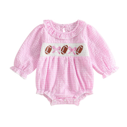 Baby girl pink gingham smocked football romper with long sleeves on a white background.