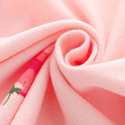 Close-up texture view of the folded, soft 100% pure cotton pink fabric, showcasing the thin, breathable material quality.