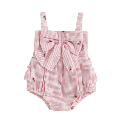 Baby girl pink and white striped seersucker romper featuring a watermelon fruit print, oversized front bow, and three-tier ruffle butt detail on a clean white background.