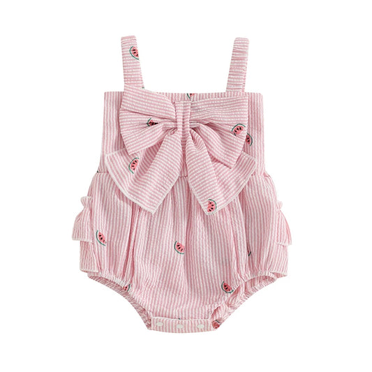 Baby girl pink and white striped seersucker romper featuring a watermelon fruit print, oversized front bow, and three-tier ruffle butt detail on a clean white background.