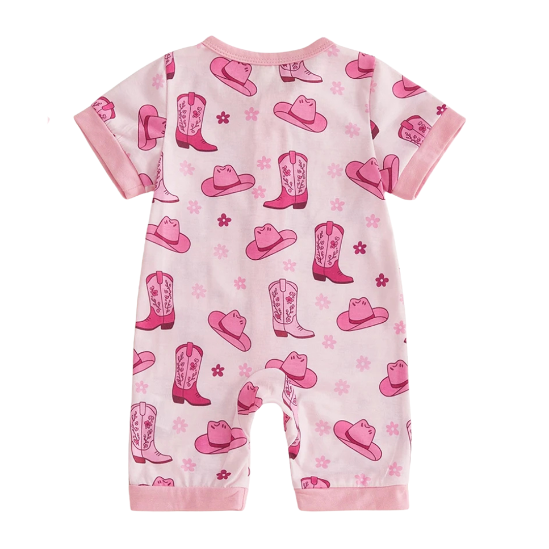 Back view of an infant baby girl short sleeve pink zip-up romper with a western cowgirl hat and boot pattern on a white background.