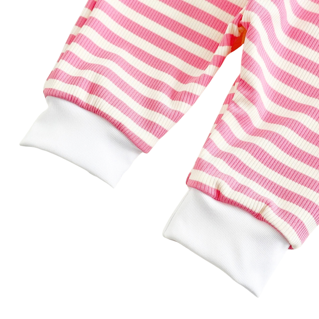 Detailed view of the pink and white striped knit jogger pants showing ribbed ankle cuffs.