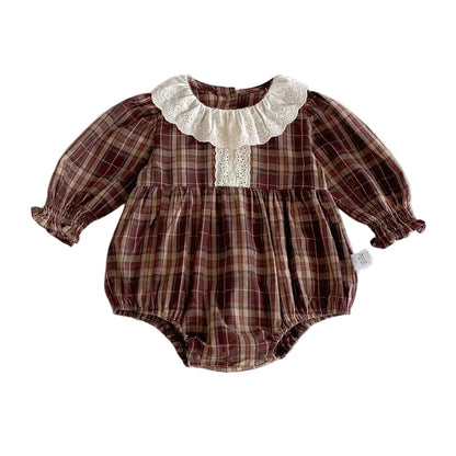 Long sleeve brown plaid baby girl bubble romper with a white eyelet lace collar and elastic leg openings.