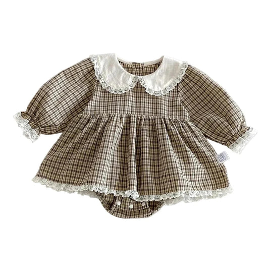 Baby girl plaid long sleeve romper dress with white lace Peter Pan collar laid flat on white background