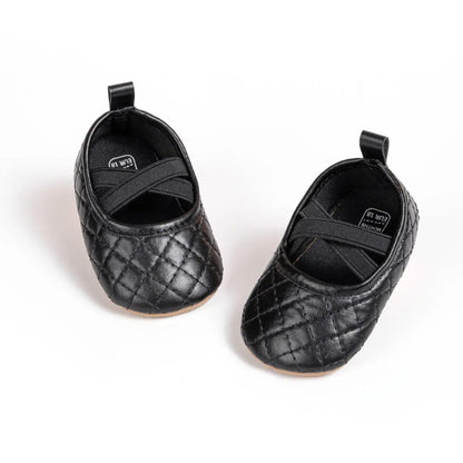 Top-down view of Kidsely black quilted baby girl pre-walker shoes featuring a comfortable elastic cross-strap.