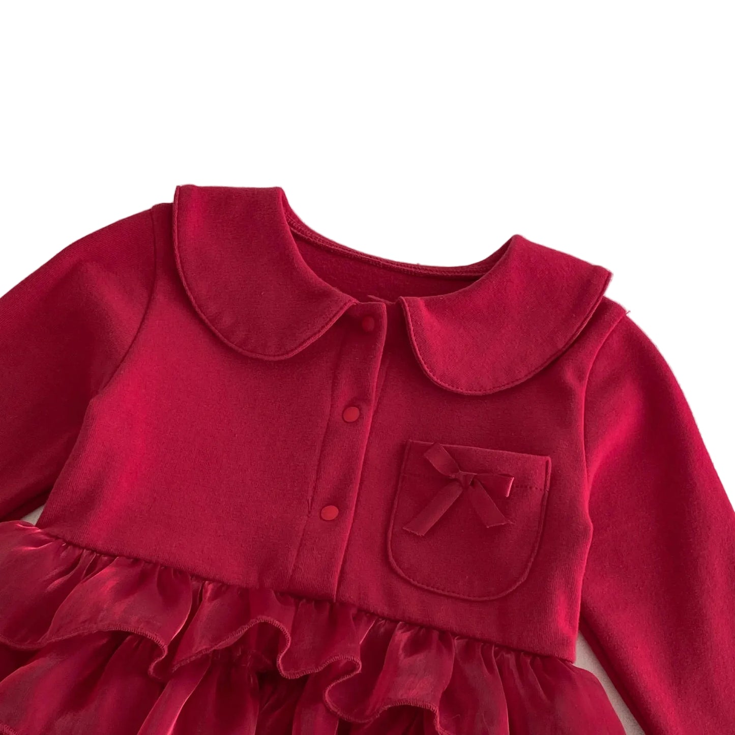 Detailed view of the deep red long-sleeve romper dress bodice, focusing on the soft cotton fabric, round collar, and cute bow pocket.