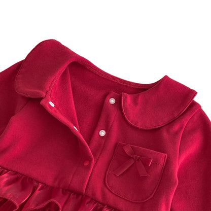 Close-up of the baby girl deep red romper dress highlighting the vintage Peter Pan collar, button placket, and chest pocket with a bow accent.