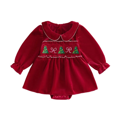 Front view of a baby girl red smocked Christmas romper dress featuring a Peter Pan collar and holiday tree embroidery.
