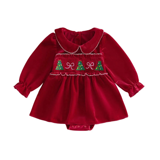 Front view of a baby girl red smocked Christmas romper dress featuring a Peter Pan collar and holiday tree embroidery.