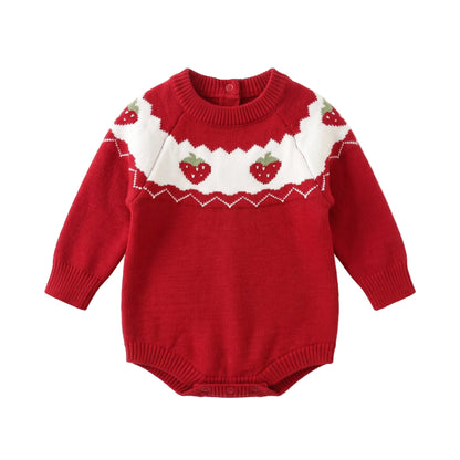 Flat lay of a baby girl red long sleeve knit sweater romper featuring a white scalloped yoke with a knit strawberry pattern.