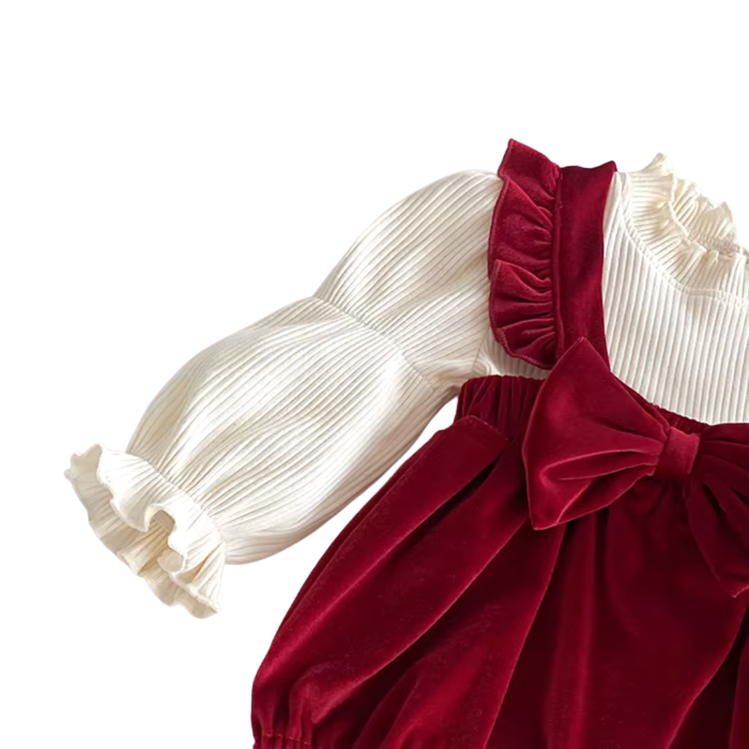 Side view of baby girl red velvet bubble suspender overall romper showing sleeve cuffs.