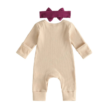 Back view of cream ribbed long sleeve baby romper with elastic bow headband