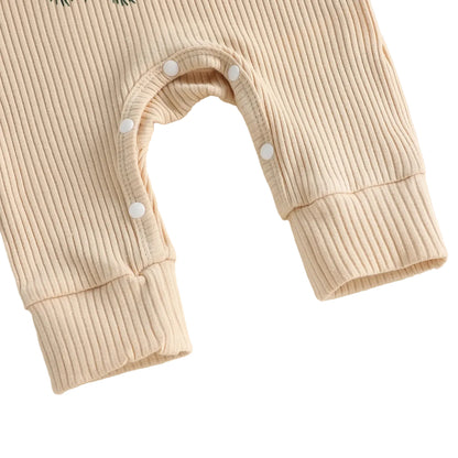 Close-up of bottom inseam snap closures on baby ribbed romper for easy diaper changes