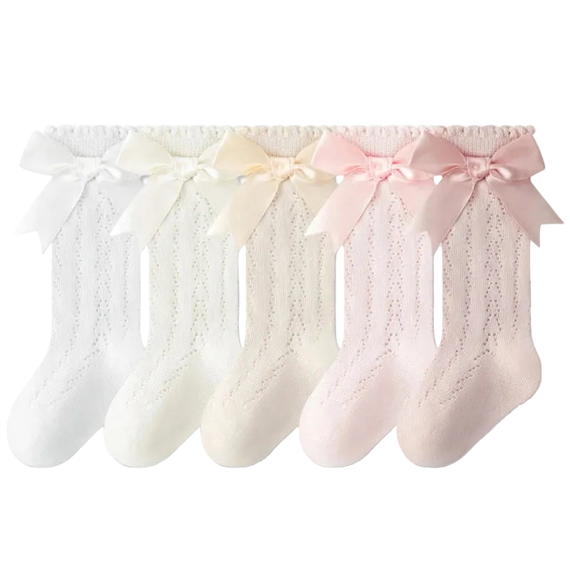 5-pack of baby and toddler girl knee high socks in a pastel mix of pink, cream, and white with silky bows.
