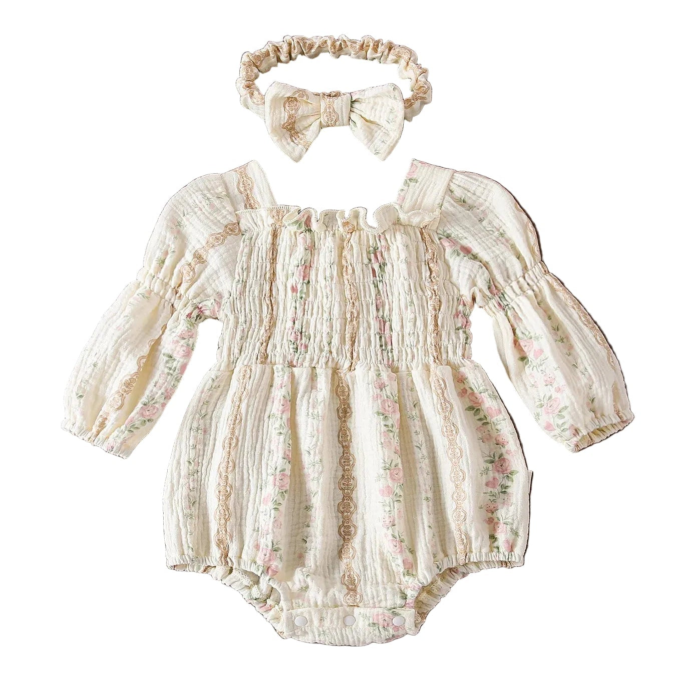 Flat lay of a baby girl's cottagecore floral smocked bubble romper with long balloon sleeves and a matching bow headband on a white background.