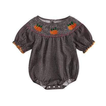 Brown smocked gingham baby romper with embroidered pumpkins across the neckline.