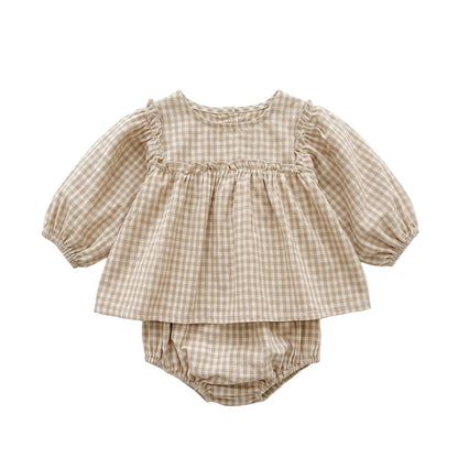 Baby girl smocked long sleeve beige gingham peplum top and matching bloomers set isolated on white background.