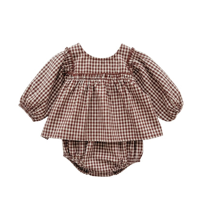 Baby girl smocked long sleeve brown gingham peplum top and matching bloomers set isolated on white background.