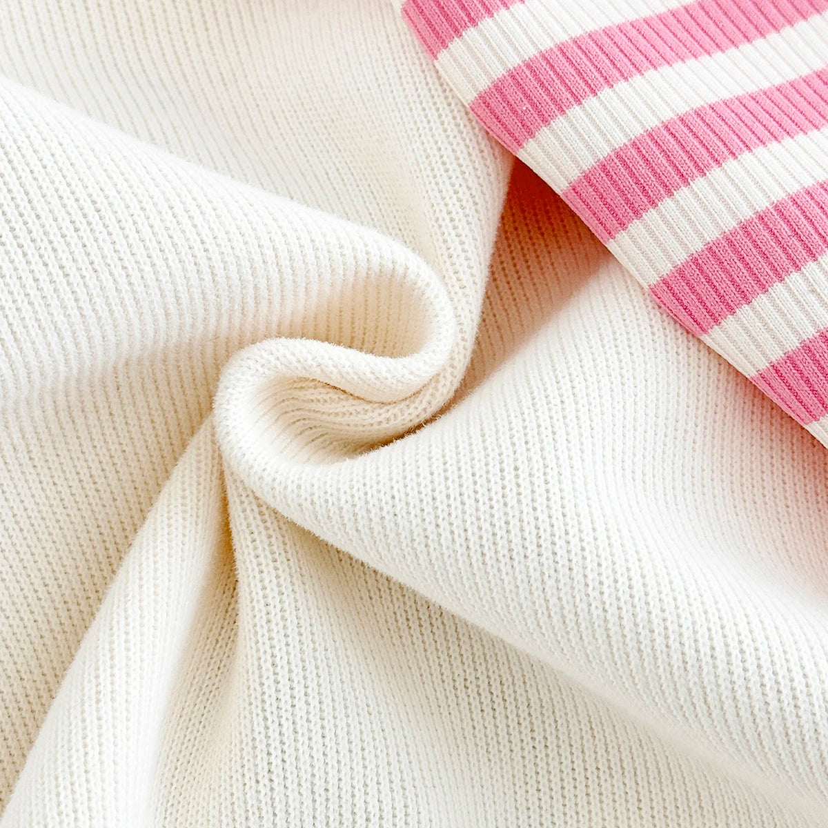Close-up showing the soft, high-quality worsted polyester knit fabric texture of the sweatshirt and pants set.